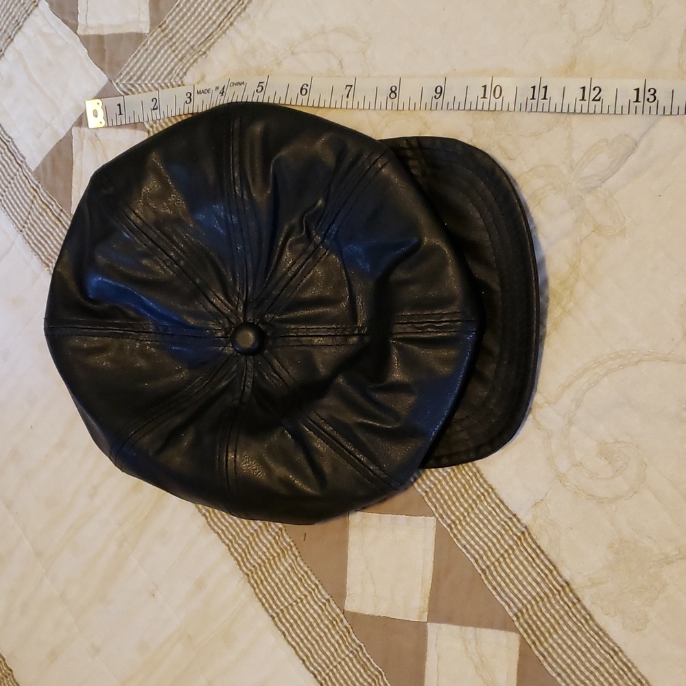 Like new leather cap. Stud details. Elastic on back.